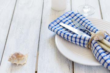 Marine style table setting on a white boards background