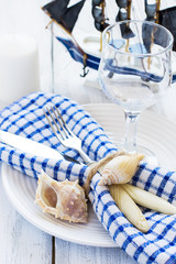 Summer table setting in marine style, decorated with shells and