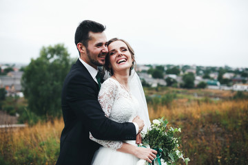 Couple is smiling happily in the wedding day