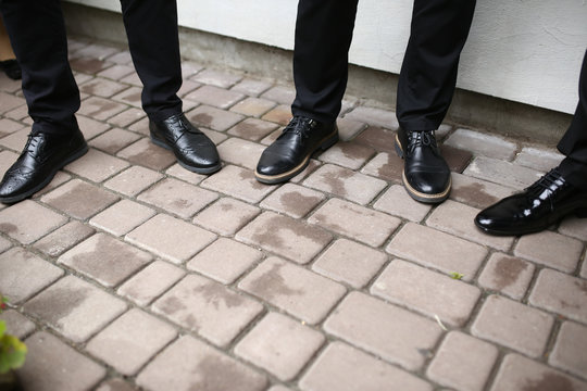 Black shoes of the groom and his best man
