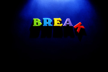 Word Break with letters and dramatic theater lighting