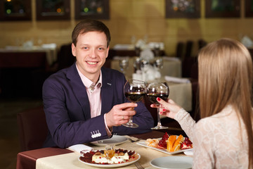 Couple toasting wineglasses in a luxury restaurant