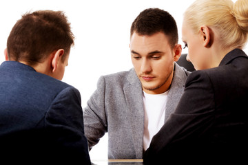 Businessman showing to people something on tablet