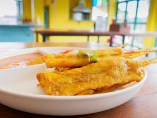 Grilled Pork Satay with Peanut Sauce in Colorful Restaurant, Tha