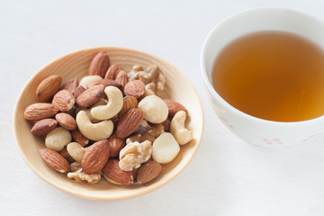 Assorted mixed nuts , Almond , Cashews nuts , macadamia , walnut with hot chinese tea