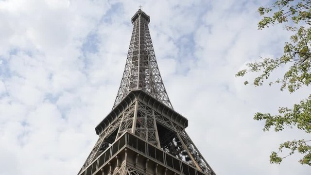 French architecture symbol Eiffel Tower tilting by the day 4K 2160p 30fps UltraHD footage -  The Eiffel Tower tilt located on Paris Champ de Mars place France 4K 3840X2160 UHD video 