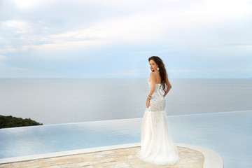 Fototapeta na wymiar Beautiful Bride in wedding dress, outdoor portrait. Brunette ele