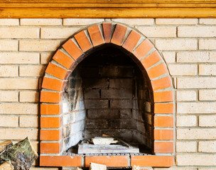 fire-box of not kindled brick fireplace