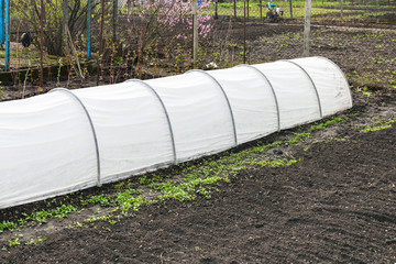 plowed garden and textile greenhouse