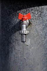 Public faucet, opened with small jet of water