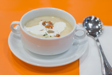 Mushroom cream soup on orange background