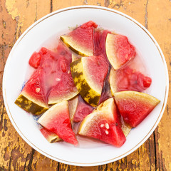 top view of pickled watermelon on white plate
