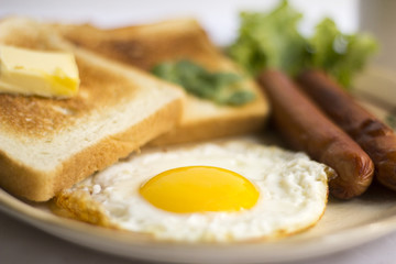 healthy breakfast fried egg yellow yolk, toast bread, sausage, vegetable in morning,  delicious sandwich diet lunch