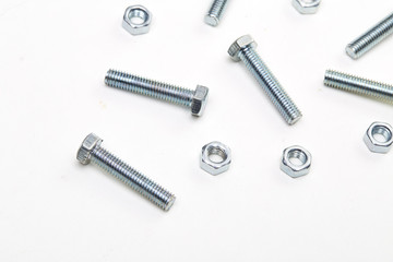 Bolts and nuts and washers on white paper
