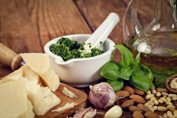 pesto sauce and ingredients over wooden rustic background