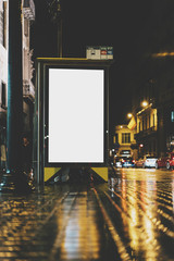 Mock up of blank light box on bus stop at night rainy day