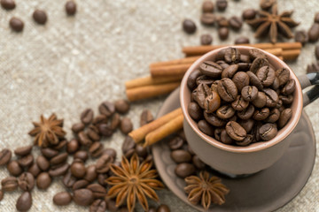 Coffee beans, cinnamon, star anise on sackcloth.