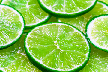 Fototapeta na wymiar Green background with citrus-fruit of lime slices