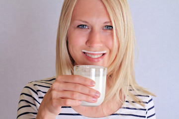 Funny young woman mustache from yogurt (milk, mustache). Dairy products concept