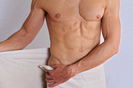 Muscular male torso, chest and armpit hair removal close up. Male Brazilian Waxing treatment