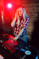 Fototapeta na wymiar Cute dj woman having fun playing music at club party