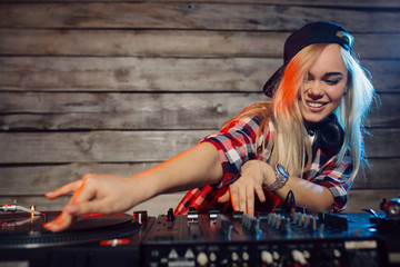 Cute dj woman having fun playing music at club party