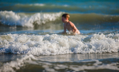 Little boy playing on the seashore