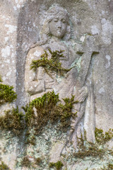 Engraved sculpture of saint on grave