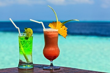 Glass of drink is on a beach table