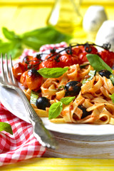 Pasta in tomato sauce with olives,basil and grilled cherry tomat