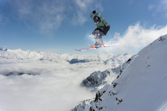 Ski rider jumping on mountains. Extreme ski freeride.