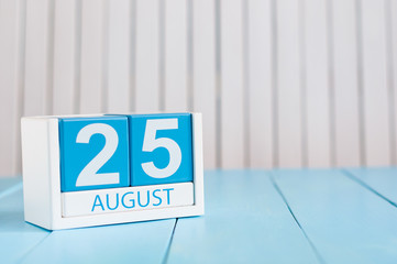August 25th. Image of august 25 wooden color calendar on blue background. Summer day. Empty space...