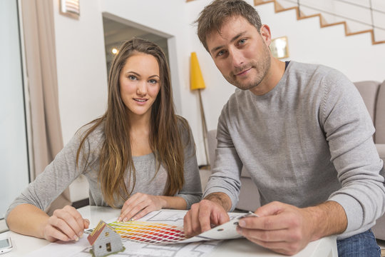 Young couple with palette of colors for her new house