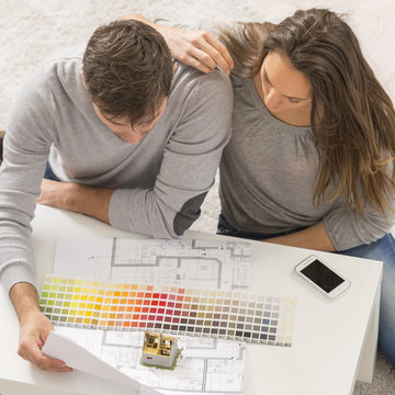 Young couple with palette of colors for her new house