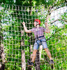 adventure climbing high wire park - people on course in mountain