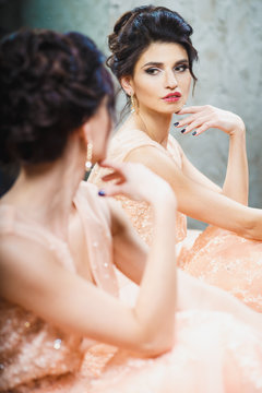 Portrait of beautiful young brunette woman in gorgeous fashionable dress