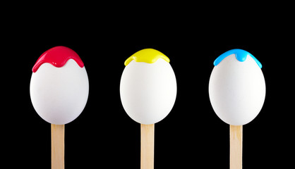 Eggs on a wooden stick doused with paint