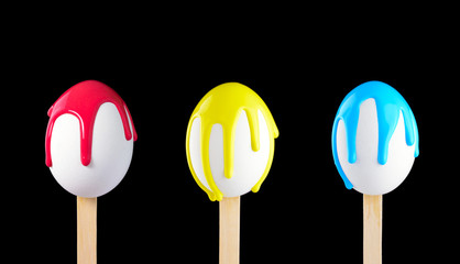 Eggs on a wooden stick doused with paint