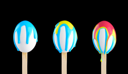 Eggs on a wooden stick doused with paint
