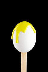 Egg on a wooden stick drenched colors