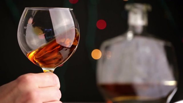 man tasting a glass of cognac