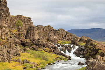 Fototapeta na wymiar Thingvellir National Park. A river flows through Thingvellir National Park in Iceland. The site is of geological importance and is one of the most popular tourist destinations in Iceland.