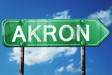 akron road sign , worn and damaged look