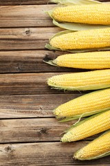 Corns on a brown wooden background