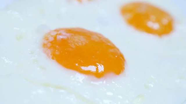Chicken egg yolk and white fried for tasty breakfast 4K 2160p 30fps UltraHD food footage - Fresh hen eggs fried on oil in frying pan with sunny side-up 4K 3840X2160 UHD video 