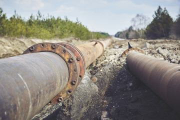 Steal big pipeline on a ground. Old pipes joint.
