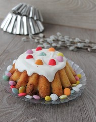 cupcake with white frosting and candies