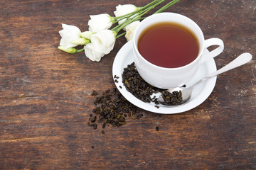 Closeup of cup of tea on vintage wooden background