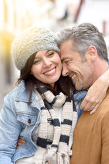 Fototapeta premium Mature man holding girlfriend in arms