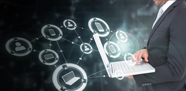 Composite image of businessman holding laptop - Powered by Adobe